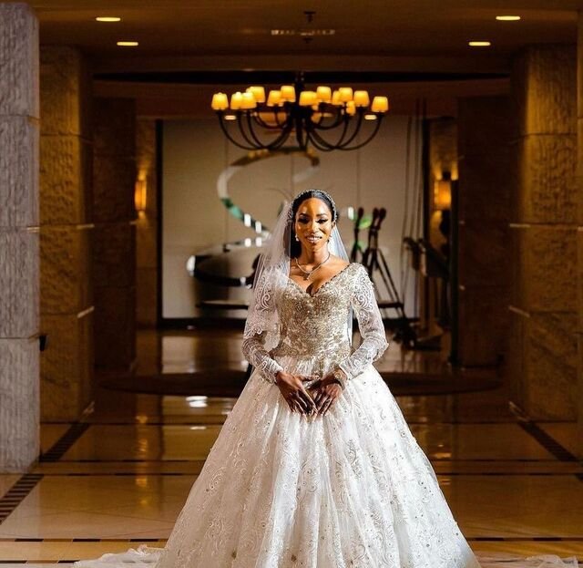 Bride in a couture lace ball gown with cathedral train by Farrah Couture