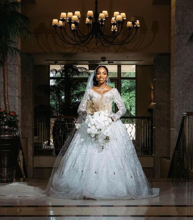 Bride in full couture gown making an entrance in a hotel ballroom