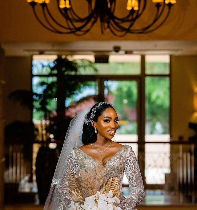 Detail of beaded bridal bodice, veil and orchid bouquet